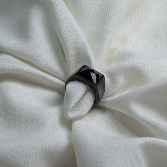 Black ring tied into a knot on white fabric