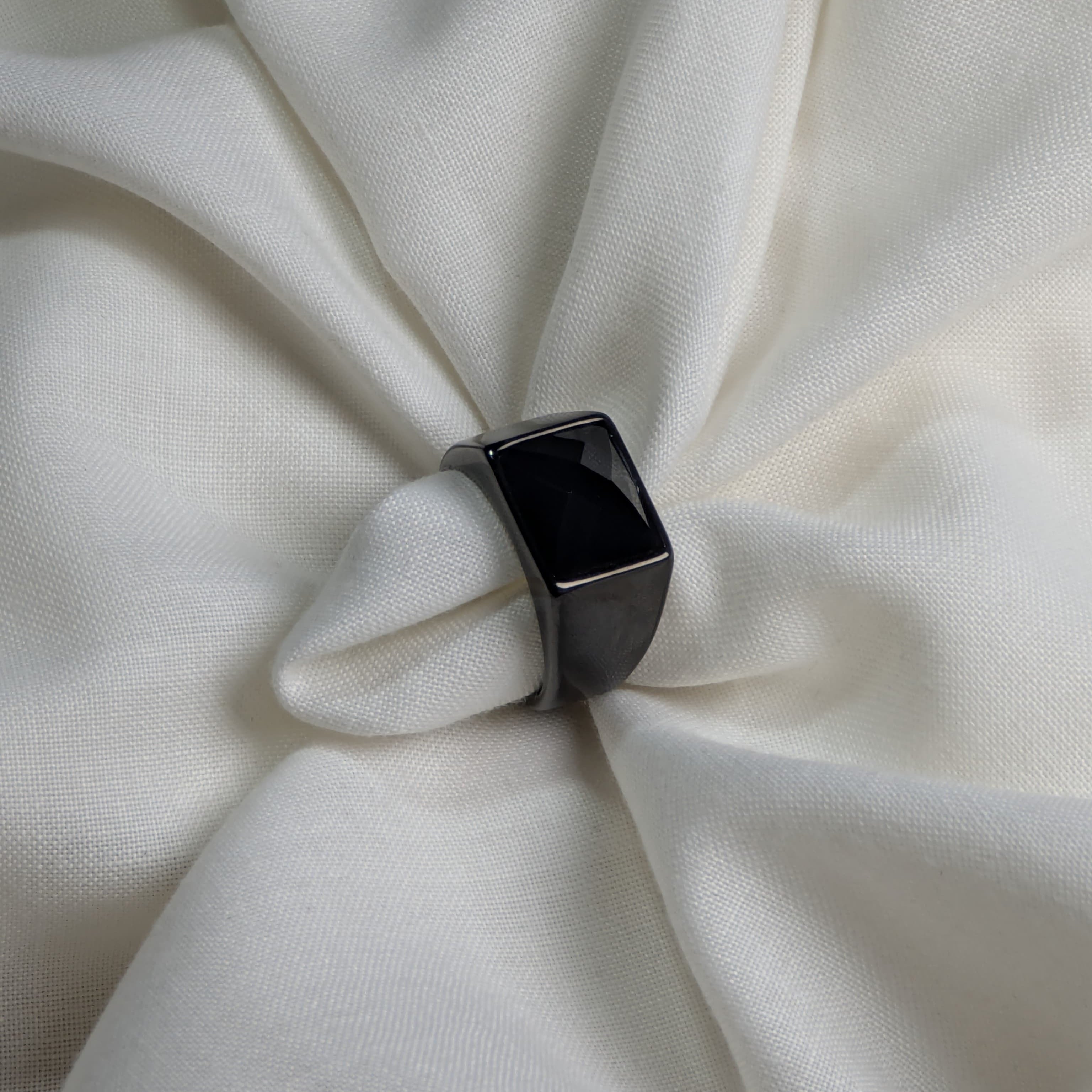 Black ring on a white fabric background