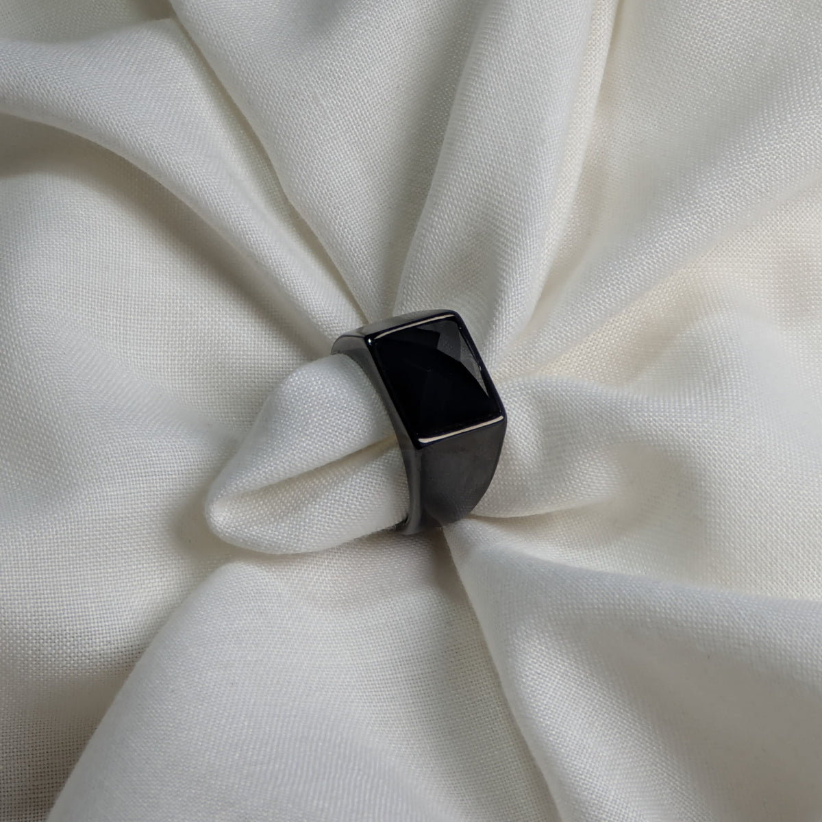 Black ring on a white fabric background