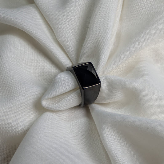 Black ring on a white fabric background