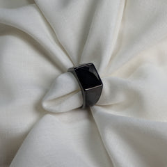 Black ring on a white fabric background